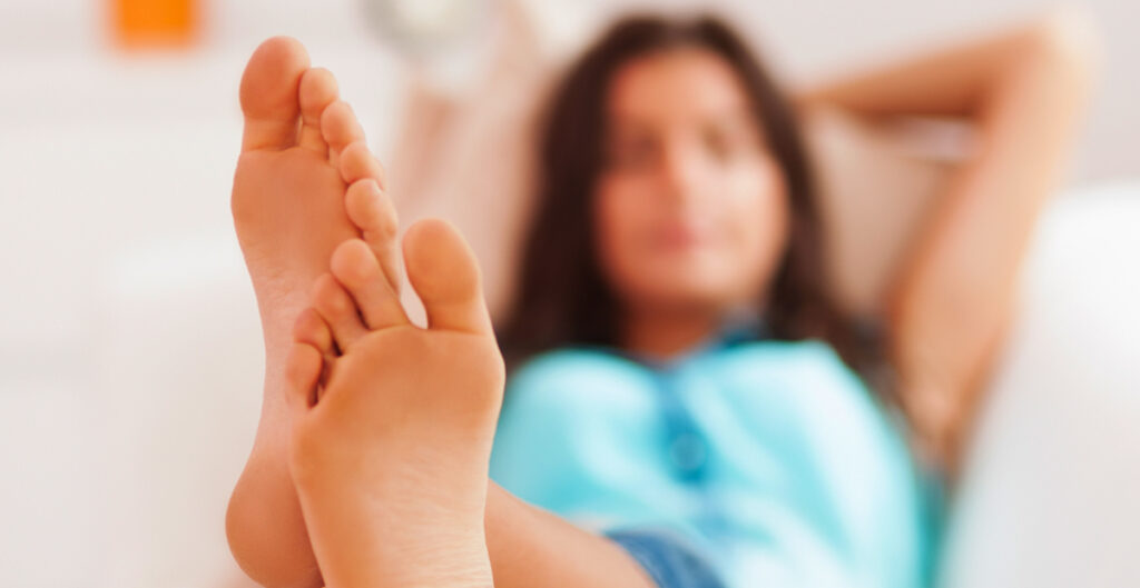 Woman with feets over couch