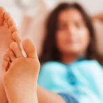 Woman with feets over couch